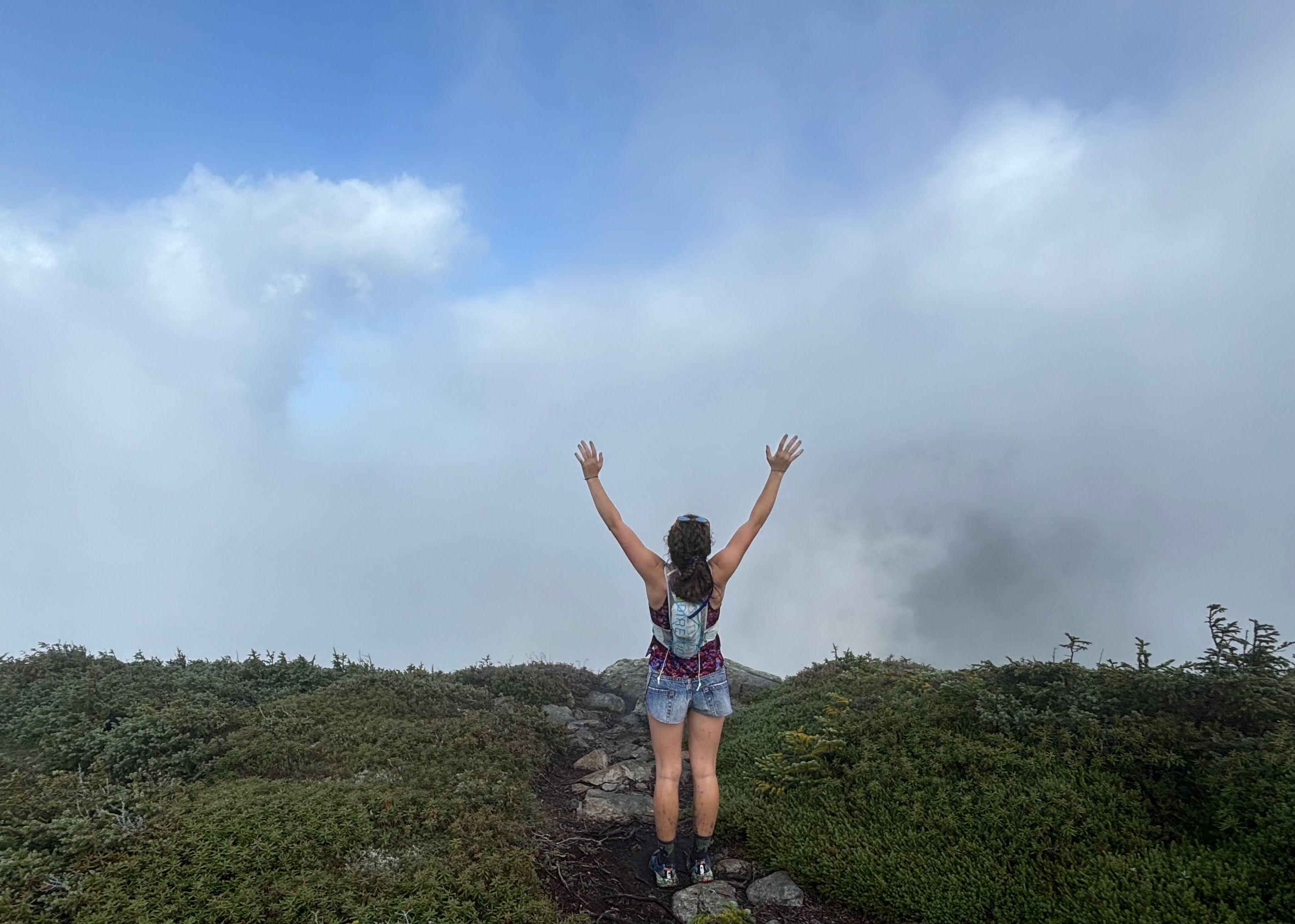Arms raised into the fog